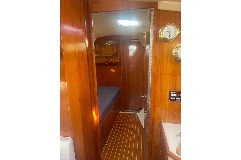 Slide: The Image of Interior of 1990 Catalina 42 sailboat with wooden paneling and nautical decor. - 10