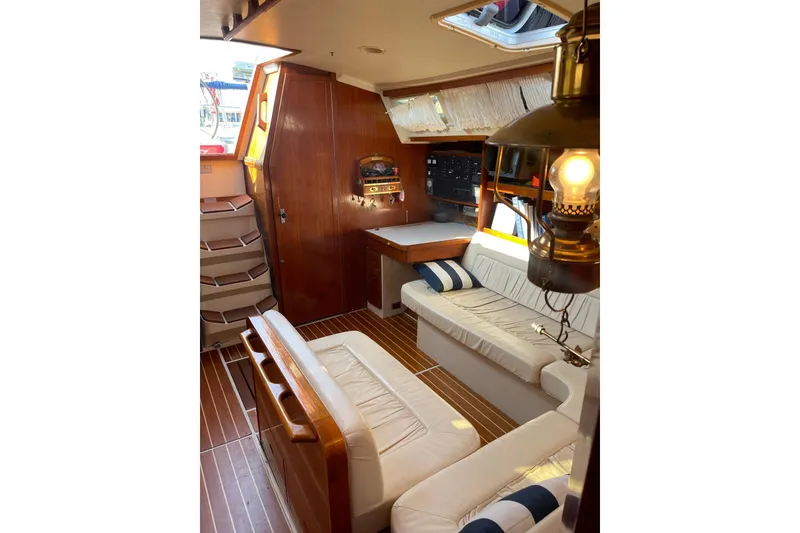 Slide: The Image of Interior of a 1990 Catalina 42 sailboat with cozy seating and nautical decor. - 12