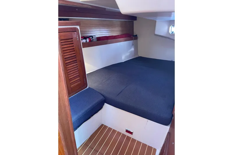 Slide: The Image of Cozy cabin interior of a 1990 Catalina 42 sailboat with wooden accents. - 13