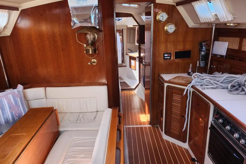 Slide: The Image of Interior of a 1990 Catalina 42 sailboat with wooden furnishings and nautical decor. - 17
