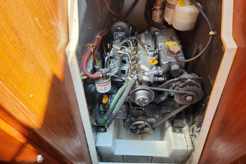 Slide: The Image of Engine compartment of a 1990 Catalina 42 sailboat, featuring a Yanmar engine. - 19