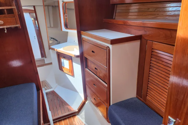 Slide: The Image of Interior of a 1990 Catalina 42 sailboat with wooden cabinetry and seating. - 21