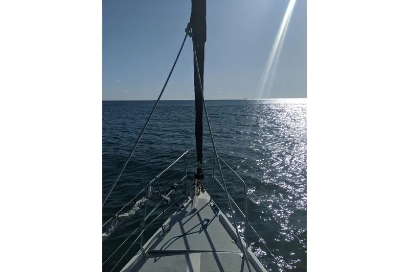 Slide: The Image of Sailing on a 1990 Catalina 42 yacht, sunlit ocean view. - 3