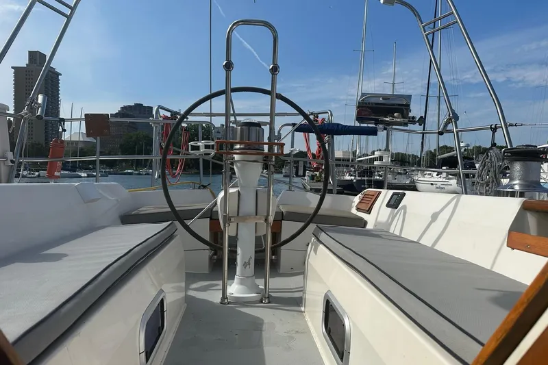 Slide: The Image of Cockpit view of a 1990 Catalina 42 sailboat docked in a marina. - 4