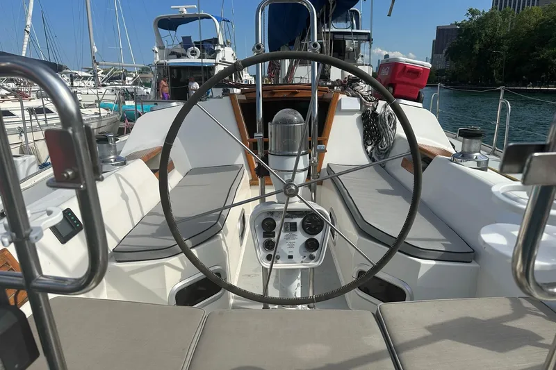 Slide: The Image of Cockpit of a 1990 Catalina 42 sailboat with steering wheel and seating. - 5
