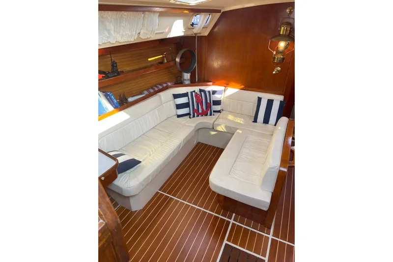 Slide: The Image of Interior of 1990 Catalina 42 yacht with white seating and nautical decor. - 7