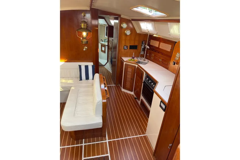 Slide: The Image of Interior of 1990 Catalina 42 sailboat with wood finish and compact kitchen area. - 8