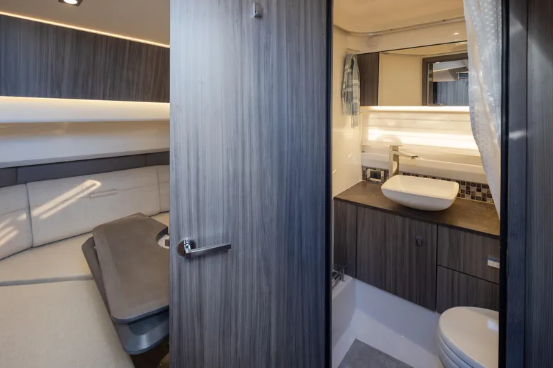 Slide: The Image of Luxurious interior of 2025 Sea Ray SLX 400 yacht featuring modern bathroom and cozy cabin. - 12
