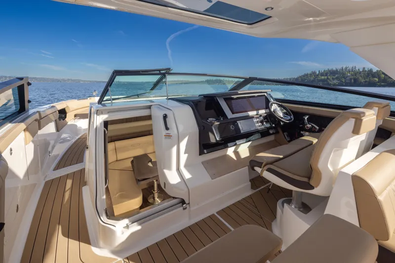 Slide: The Image of Luxurious 2025 Sea Ray SLX 400 boat interior with helm, seating, and scenic water view. - 25