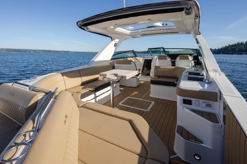 Slide: The Image of 2025 Sea Ray SLX 400 luxury boat interior with spacious seating and elegant design on open water. - 27