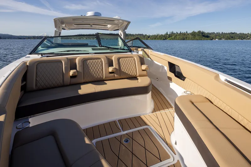 Slide: The Image of 2025 Sea Ray SLX 400 boat interior with luxurious seating on a serene lake. - 34