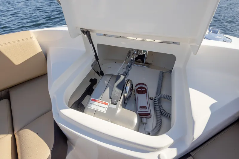 Slide: The Image of 2025 Sea Ray SLX 400 anchor compartment with winch and control panel. - 36
