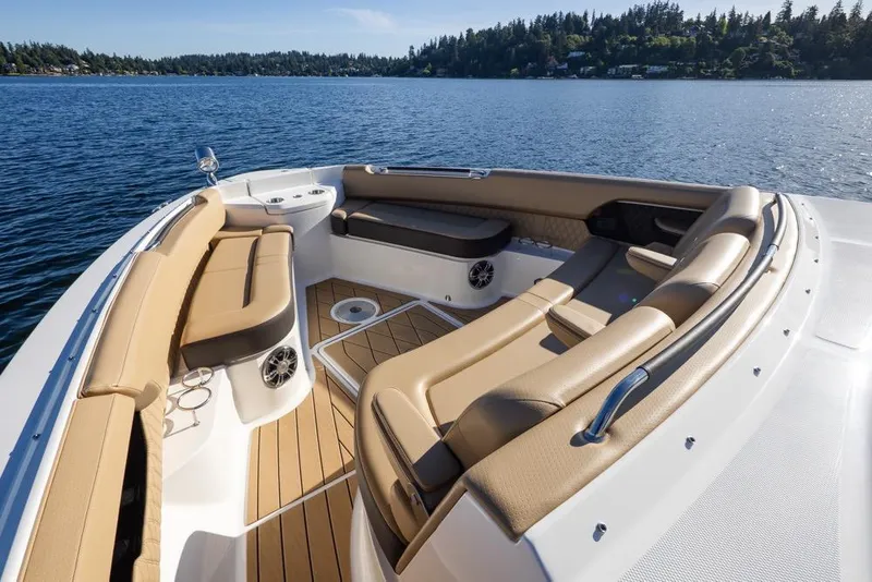 Slide: The Image of Luxurious 2025 Sea Ray SLX 400 boat interior with tan seating on a serene lake. - 39