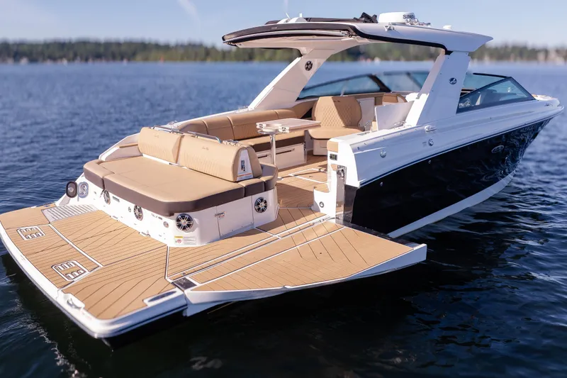 Slide: The Image of 2025 Sea Ray SLX 400 luxury boat on calm water, featuring spacious deck and seating. - 8
