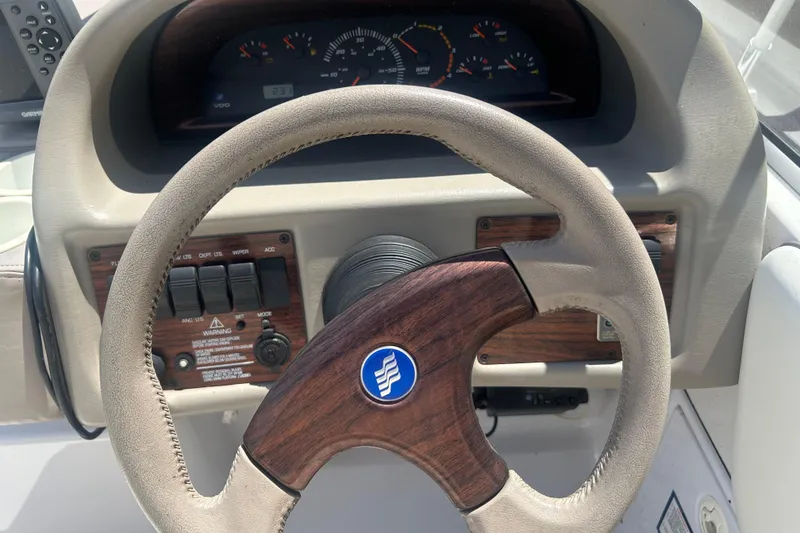 Slide: The Image of Steering wheel and dashboard of a 1998 Four Winns 258 Vista boat. - 11