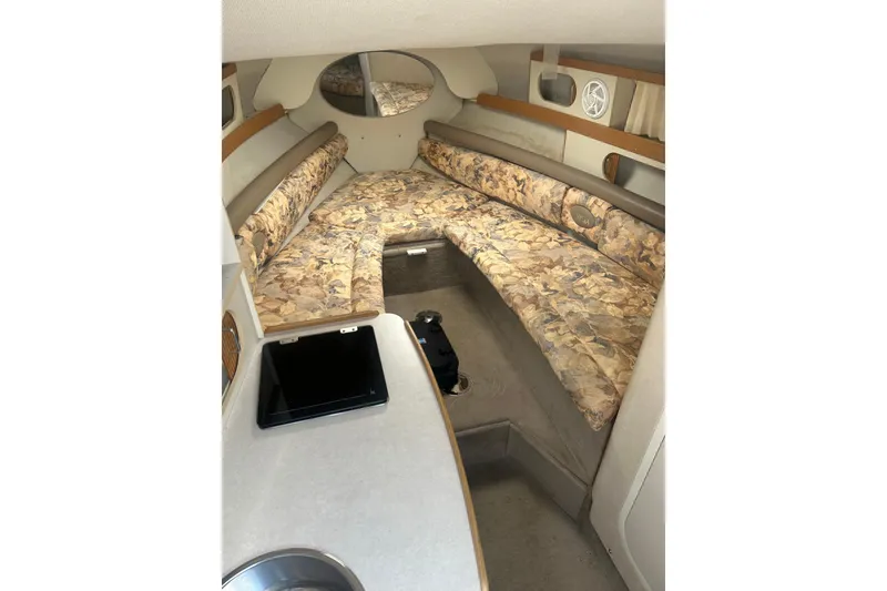Slide: The Image of 1998 Four Winns 258 Vista cabin interior with floral upholstery and compact kitchenette. - 14