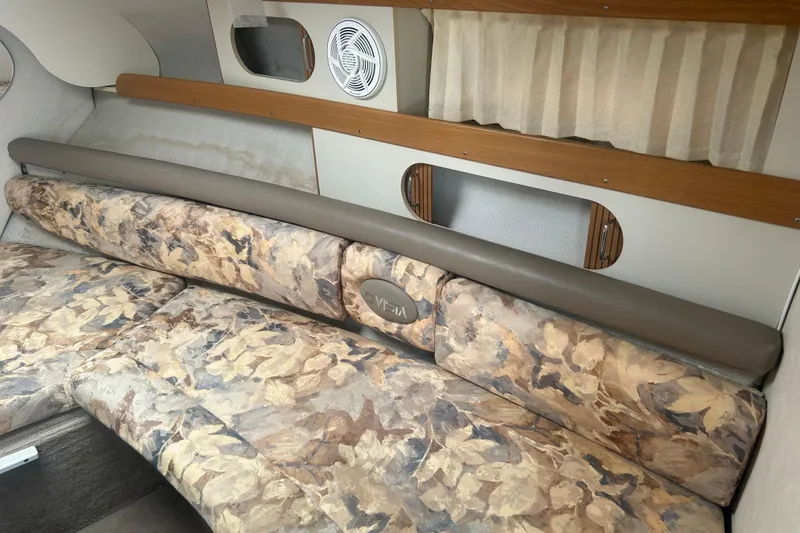 Slide: The Image of Interior of a 1998 Four Winns 258 Vista boat with floral-patterned seating. - 19