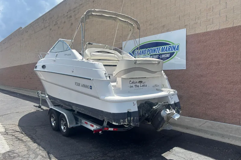 Slide: The Image of 1998 Four Winns 258 Vista boat on trailer at Grand Pointe Marina. - 2