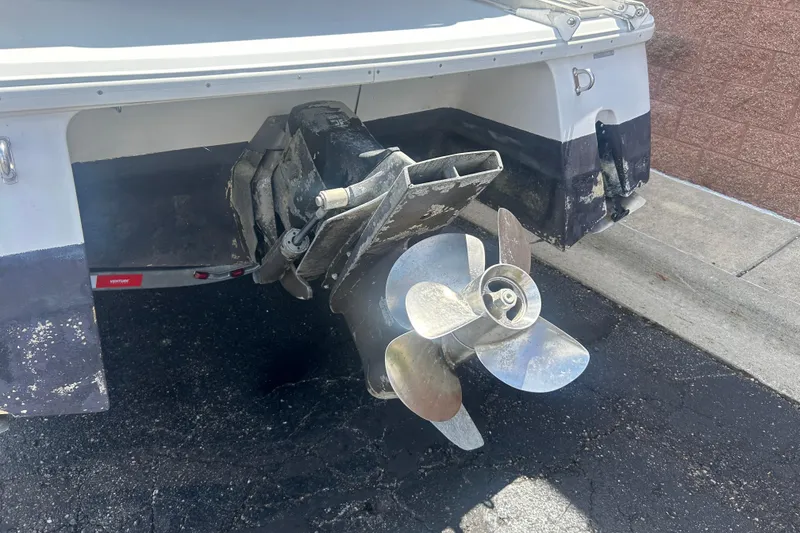 Slide: The Image of 1998 Four Winns 258 Vista boat stern with propeller and outdrive visible. - 21