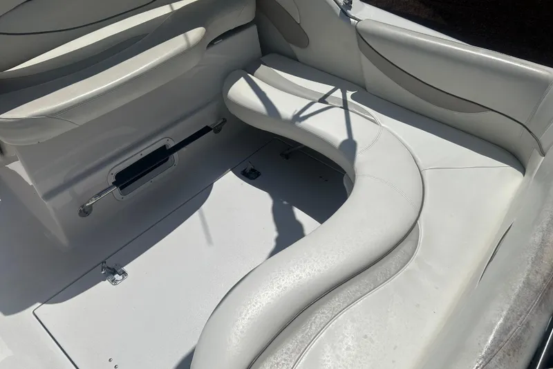 Slide: The Image of 1998 Four Winns 258 Vista boat interior with white cushioned seating. - 9