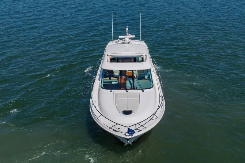 Slide: The Image of 2020 Tiara Yachts C53 Coupe cruising on open water, aerial view. - 11