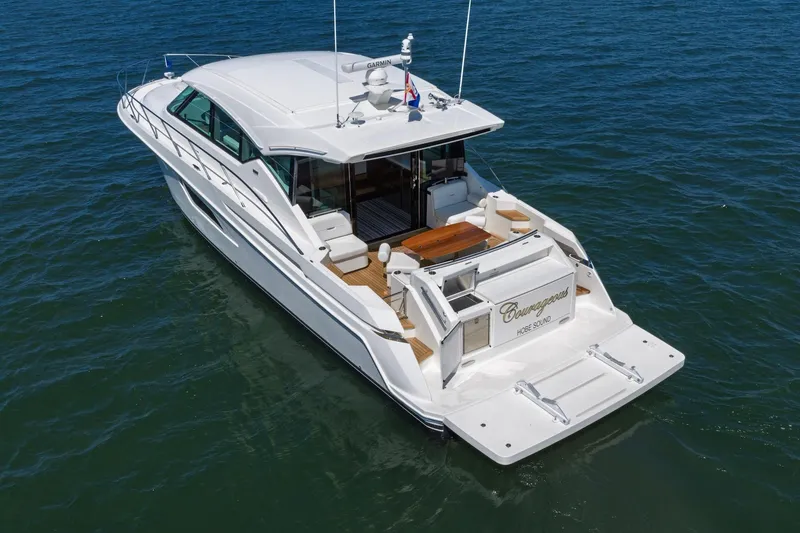Slide: The Image of 2020 Tiara Yachts C53 Coupe cruising on open water, rear view. - 16