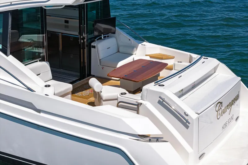 Slide: The Image of 2020 Tiara Yachts C53 Coupe with elegant deck and seating area on the water. - 17