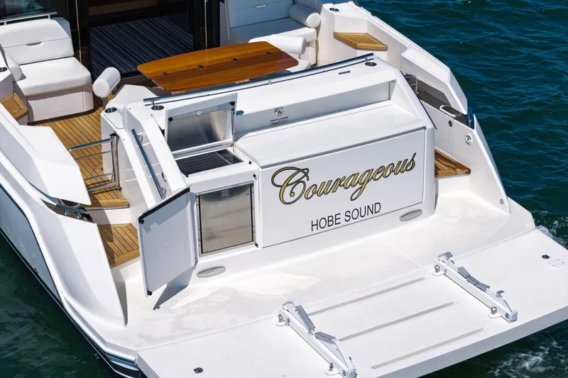 Slide: The Image of 2020 Tiara Yachts C53 Coupe with "Courageous" name, docked on water. - 19
