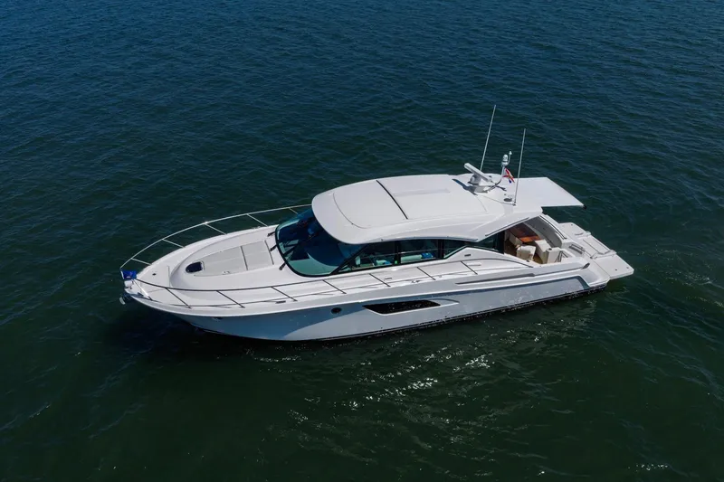 Slide: The Image of 2020 Tiara Yachts C53 Coupe cruising on open water. - 24