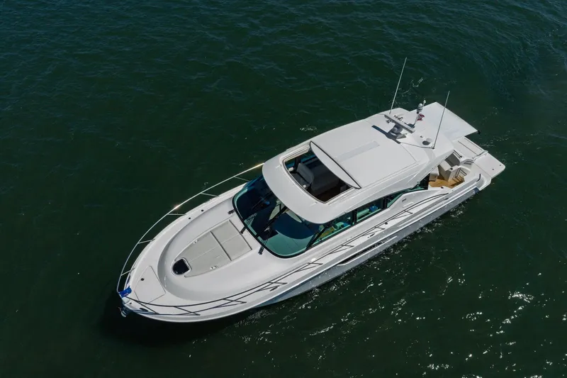 Slide: The Image of 2020 Tiara Yachts C53 Coupe cruising on open water, aerial view. - 25