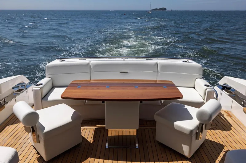 Slide: The Image of Luxury seating area on 2020 Tiara Yachts C53 Coupe, overlooking ocean waters. - 28