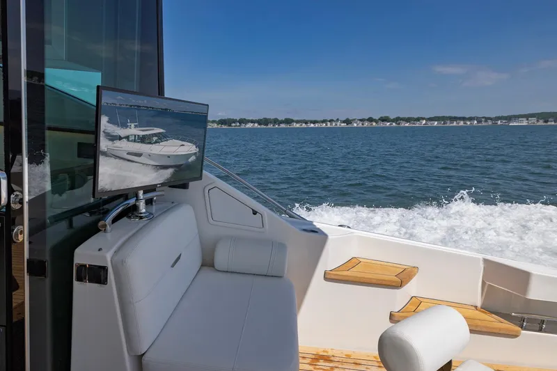Slide: The Image of 2020 Tiara Yachts C53 Coupe interior with ocean view and mounted TV display. - 29