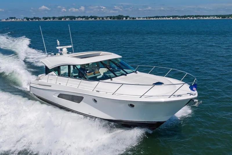 Slide: The Image of 2020 Tiara Yachts C53 Coupe cruising on open water, showcasing sleek design and performance. - 3