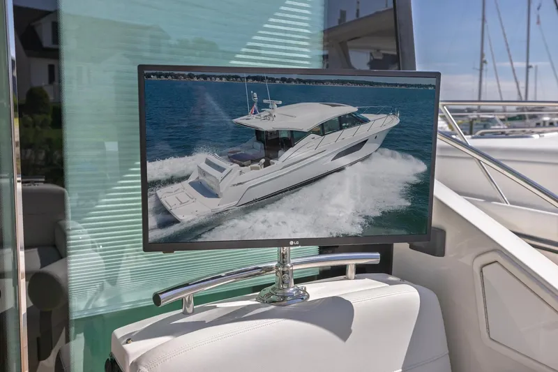 Slide: The Image of 2020 Tiara Yachts C53 Coupe displayed on a boat's TV screen. - 30