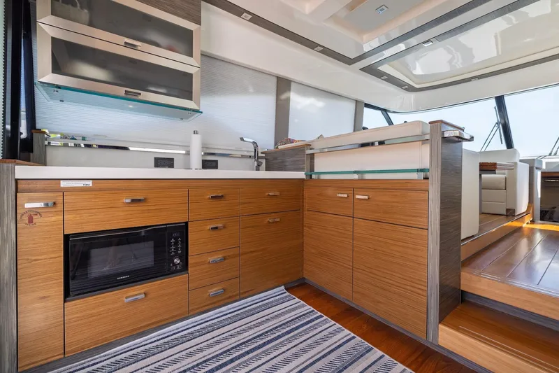 Slide: The Image of Modern kitchen interior of 2020 Tiara Yachts C53 Coupe with wood cabinetry and sleek design. - 36