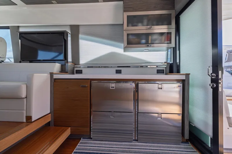 Slide: The Image of Interior of 2020 Tiara Yachts C53 Coupe featuring modern kitchen and entertainment area. - 38