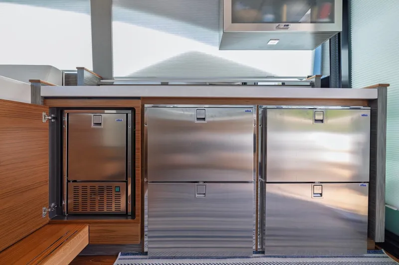 Slide: The Image of Modern kitchen area in 2020 Tiara Yachts C53 Coupe with stainless steel appliances. - 39