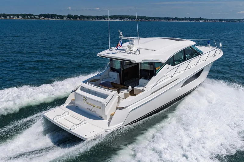 Slide: The Image of 2020 Tiara Yachts C53 Coupe cruising on open water, showcasing sleek design and luxury. - 4