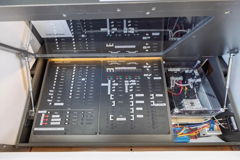 Slide: The Image of Electrical control panel of a 2020 Tiara Yachts C53 Coupe, showcasing wiring and switches. - 46