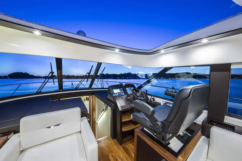 Slide: The Image of Manufacturer Provided Image: 2020 Tiara Yachts C53 Coupe helm station with panoramic windows at sunset. - 48