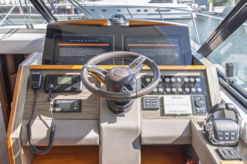 Slide: The Image of Cockpit of 2020 Tiara Yachts C53 Coupe with advanced navigation controls and steering wheel. - 49