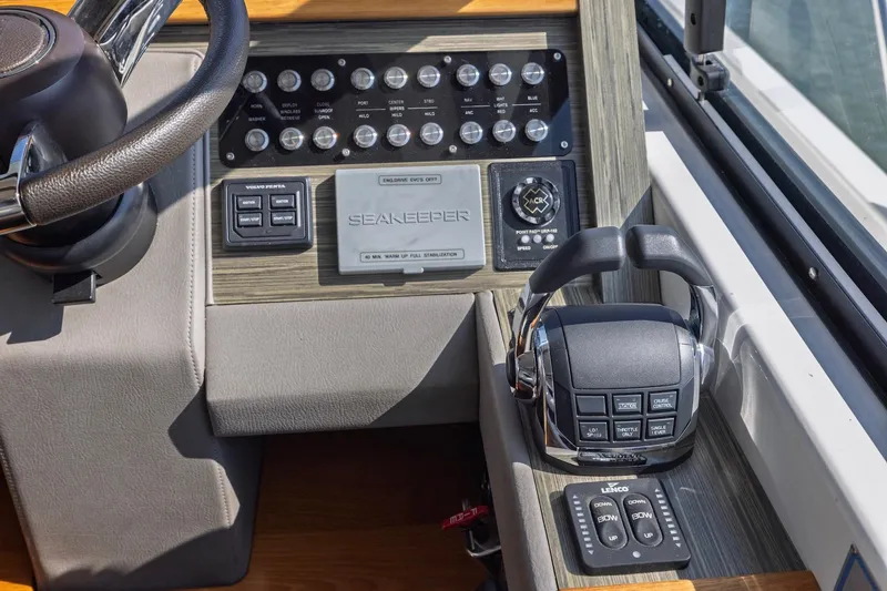 Slide: The Image of Control panel of a 2020 Tiara Yachts C53 Coupe with steering wheel and throttle controls. - 51