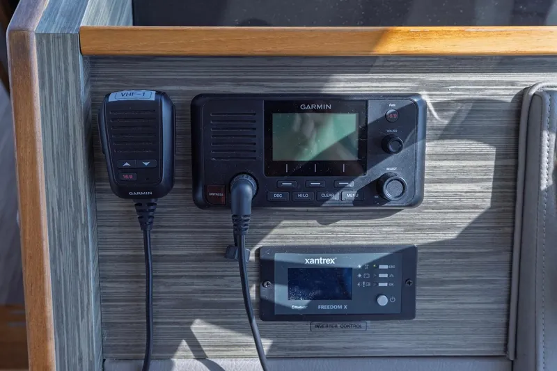 Slide: The Image of Control panel of a 2020 Tiara Yachts C53 Coupe featuring Garmin and Xantrex devices. - 53