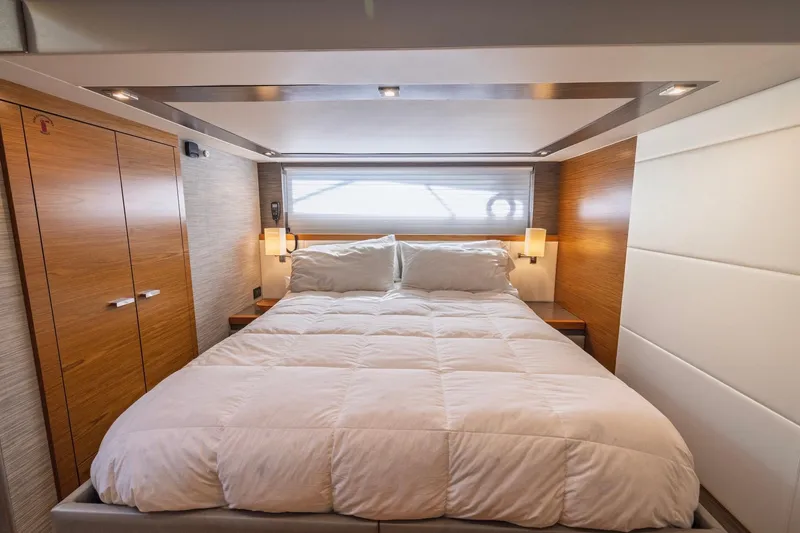Slide: The Image of Luxurious bedroom interior of 2020 Tiara Yachts C53 Coupe with modern wood paneling. - 59