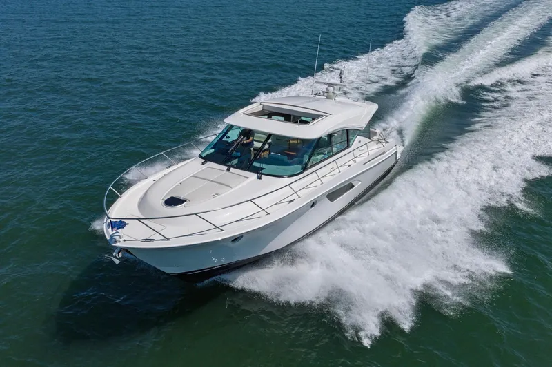 Slide: The Image of 2020 Tiara Yachts C53 Coupe cruising on open water, showcasing sleek design and performance. - 6