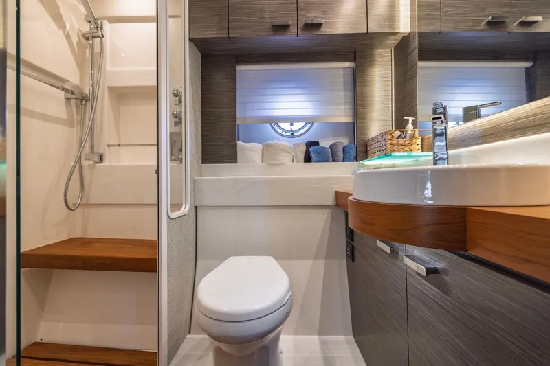 Slide: The Image of Luxurious bathroom interior of 2020 Tiara Yachts C53 Coupe with modern fixtures and wooden accents. - 66