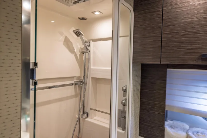 Slide: The Image of Luxurious shower area in 2020 Tiara Yachts C53 Coupe, featuring modern fixtures and wood accents. - 68
