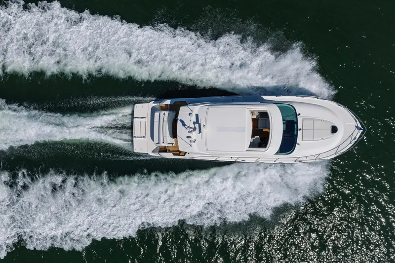 Slide: The Image of Aerial view of 2020 Tiara Yachts C53 Coupe cruising on water. - 7