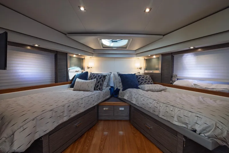 Slide: The Image of Luxurious 2020 Tiara Yachts C53 Coupe cabin with twin beds and elegant decor. - 71