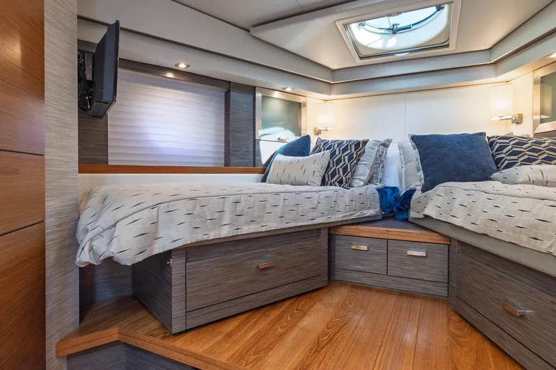 Slide: The Image of Luxurious 2020 Tiara Yachts C53 Coupe cabin interior with elegant bedding and modern design. - 72